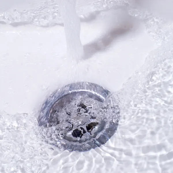 Faucet water going down a drain