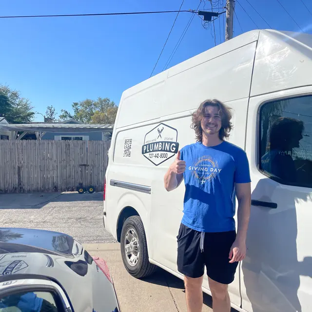 A Hafke Plumbing customer photographed beside a Hafke service van after a completed job