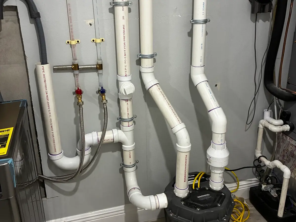 Commercial drain piping and pump in a utility room