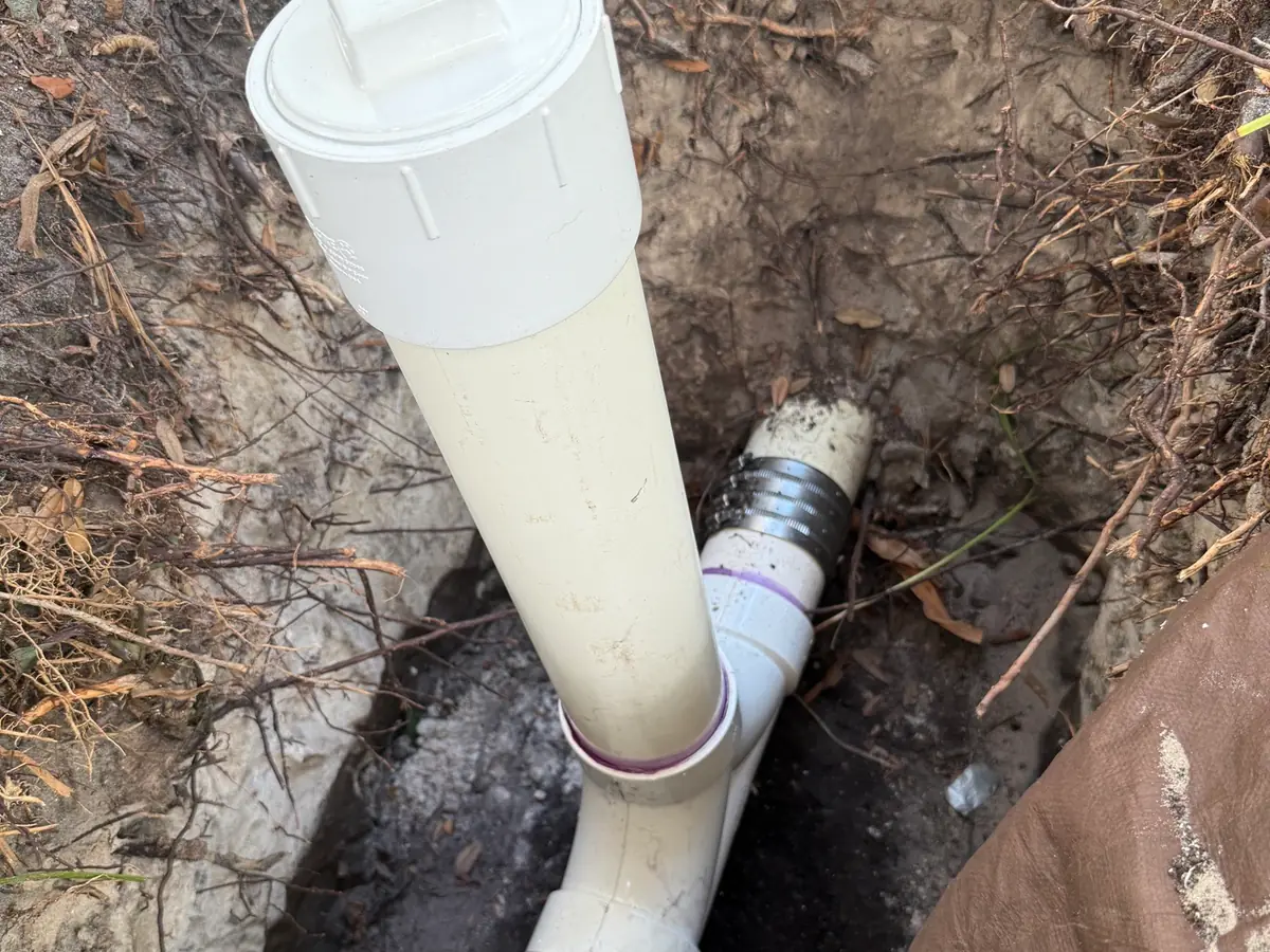 Exterior drain cleanout opened for cable access