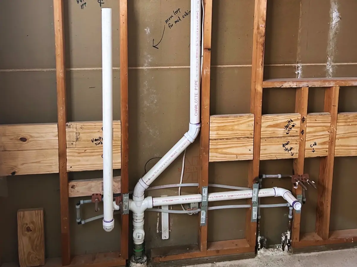 Drain and vent piping roughed into an open wall during a remodel