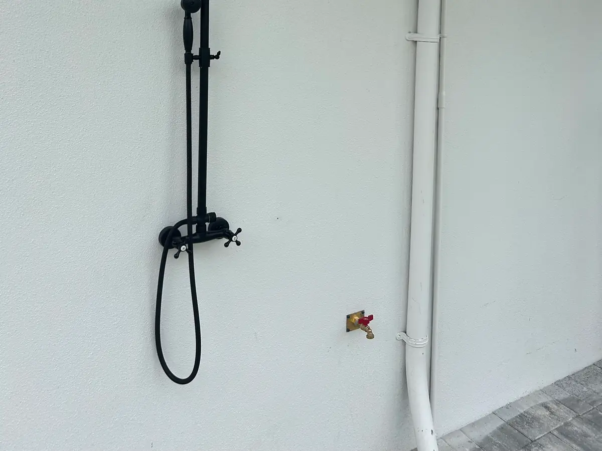 Upgraded rainfall shower fixture installed on a tiled wall