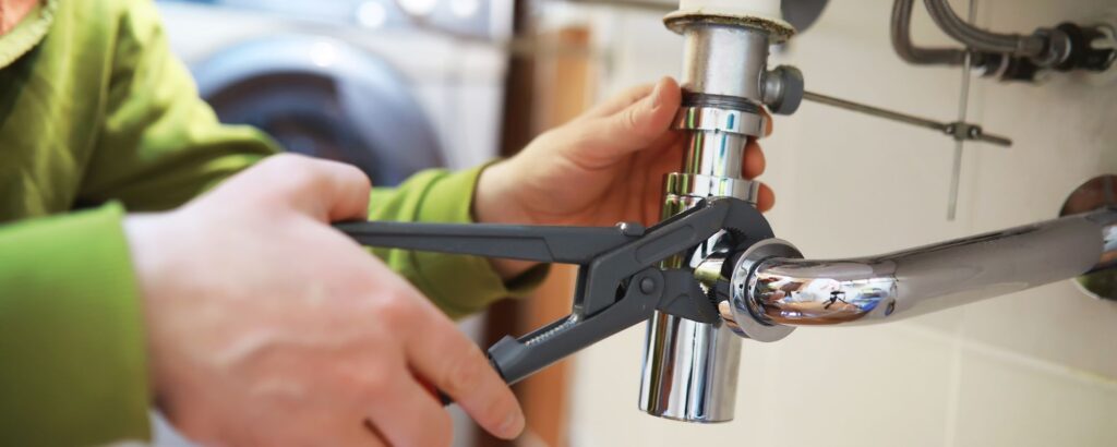 plumber adjusting sink