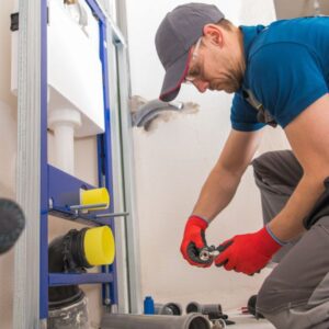 A plumber working on a pipe