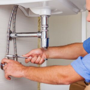 A plumber tightening a bolt