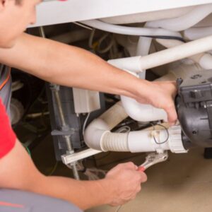 A plumber installing plumbing pipes