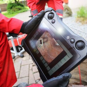 someone views a screen showing a drain system inspection 