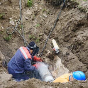 professional plumbers fixing a water main