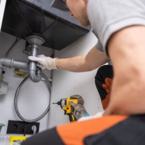 Man cleaning sink drain