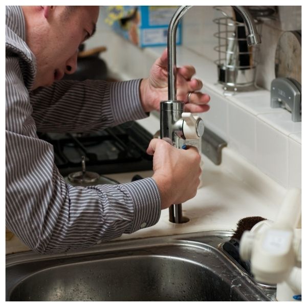 plumber replacing faucet