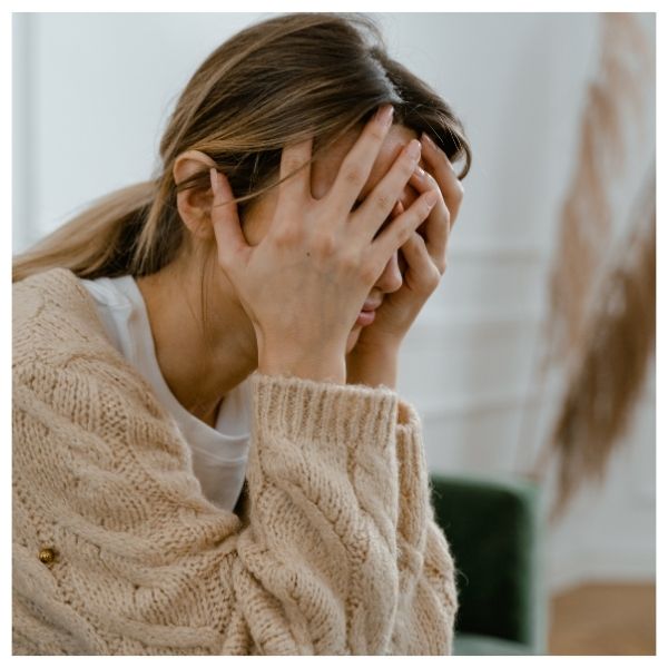 worried woman with her head in her hands