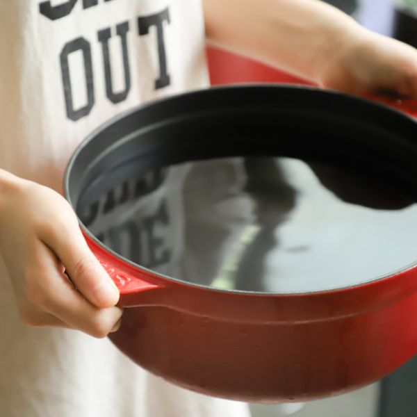 woman holding water in a pot