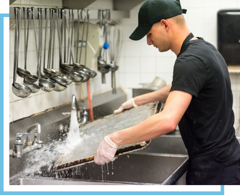 cleaning dishes in restaurant kitchen