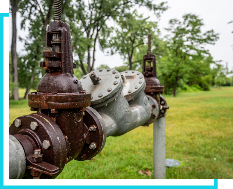Exterior view of a large commercial backflow prevention assembly installed on an outdoor water service line in the Tampa Bay area.