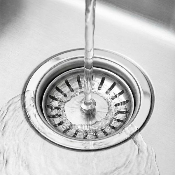 Water flowing into a sink drain.