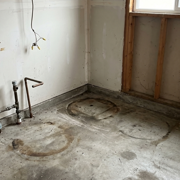 an empty garage corner where a bulky tank used to sit